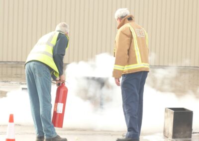 Course participant extinguishing a controlled fire with supervision
